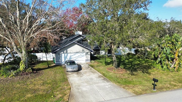 view of home's exterior featuring a garage and a lawn