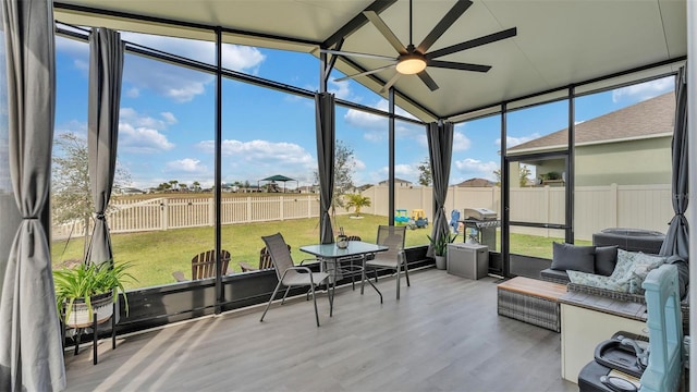 sunroom featuring vaulted ceiling and ceiling fan