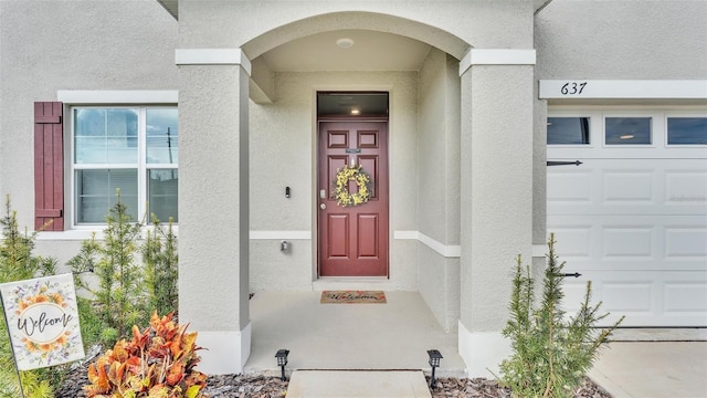 view of exterior entry with a garage