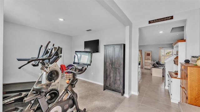 workout room featuring light tile patterned floors