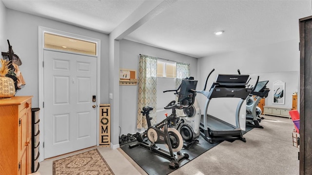 exercise area featuring a textured ceiling