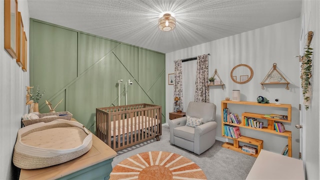 bedroom featuring a crib and light colored carpet