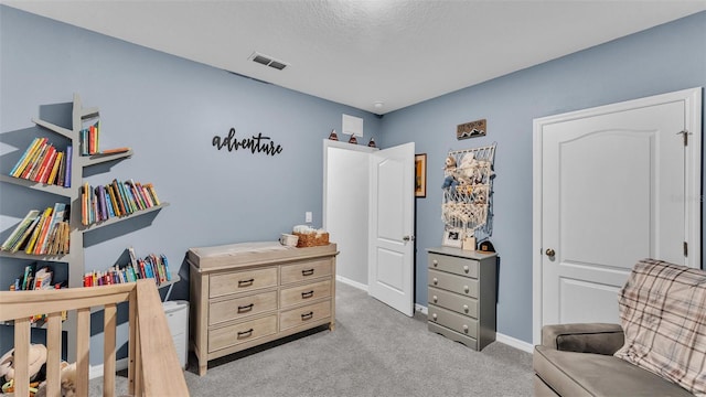 carpeted bedroom with a textured ceiling