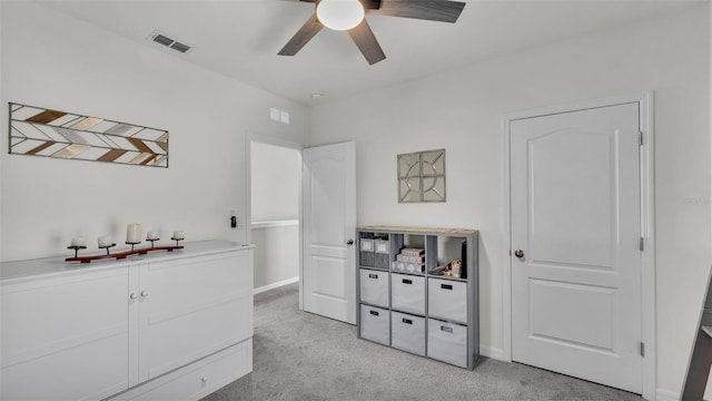 bedroom with light carpet and ceiling fan