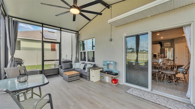 sunroom featuring lofted ceiling and ceiling fan