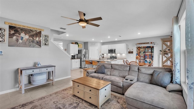 living area with light tile patterned floors, recessed lighting, visible vents, and ceiling fan