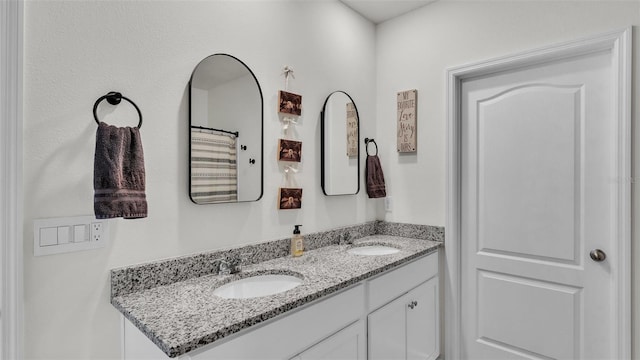 full bath with a sink and double vanity