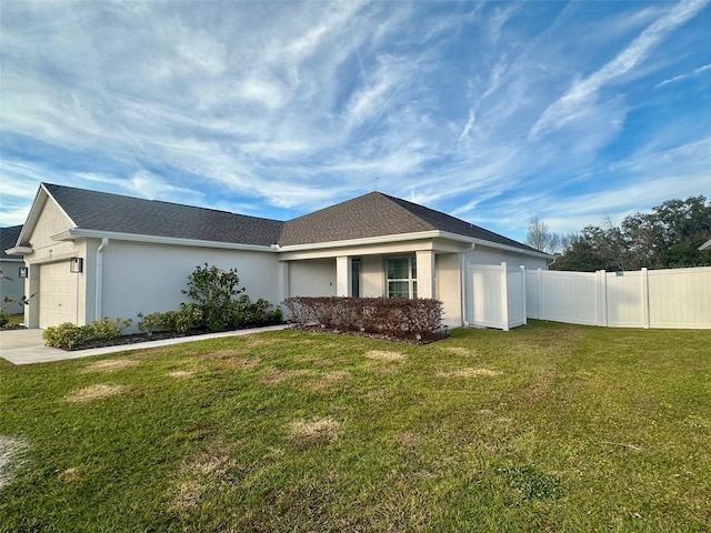 view of front facade with a garage and a front lawn