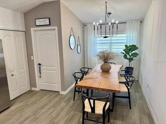 dining space with an inviting chandelier and lofted ceiling