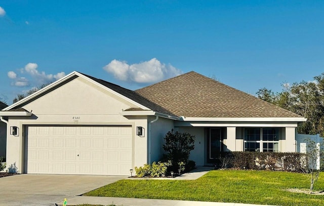 ranch-style house with a garage and a front lawn