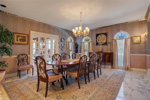 dining area featuring french doors and an inviting chandelier