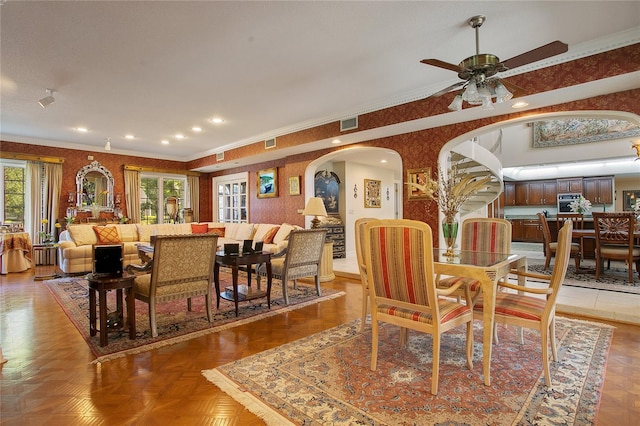 dining space featuring crown molding, parquet flooring, and ceiling fan