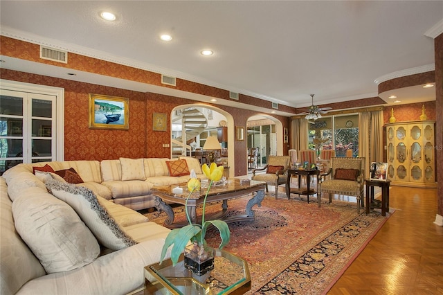 living room with parquet floors, crown molding, and ceiling fan