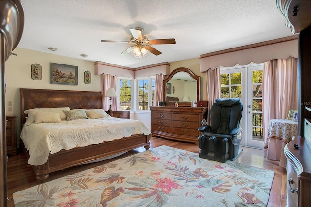 bedroom featuring light hardwood / wood-style flooring, ceiling fan, access to exterior, a textured ceiling, and french doors