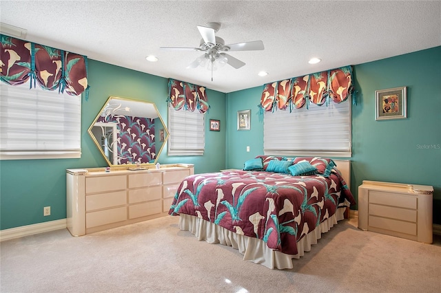 bedroom featuring ceiling fan, carpet flooring, and a textured ceiling