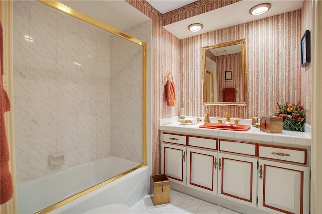 bathroom with vanity and bath / shower combo with glass door