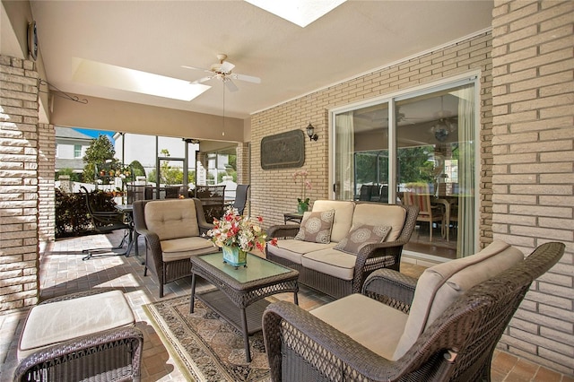 sunroom featuring a skylight and ceiling fan