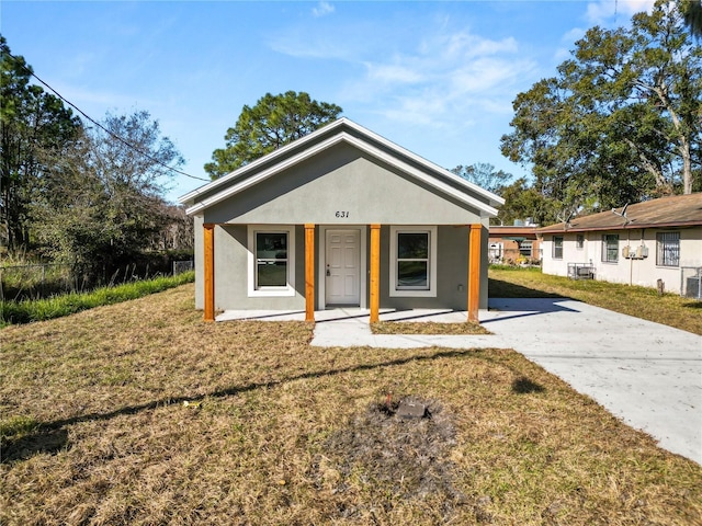 bungalow-style home featuring a porch, central air condition unit, and a front lawn