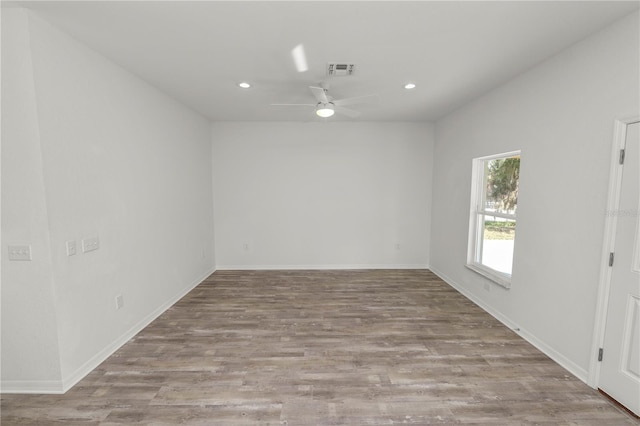 spare room featuring ceiling fan and light hardwood / wood-style floors