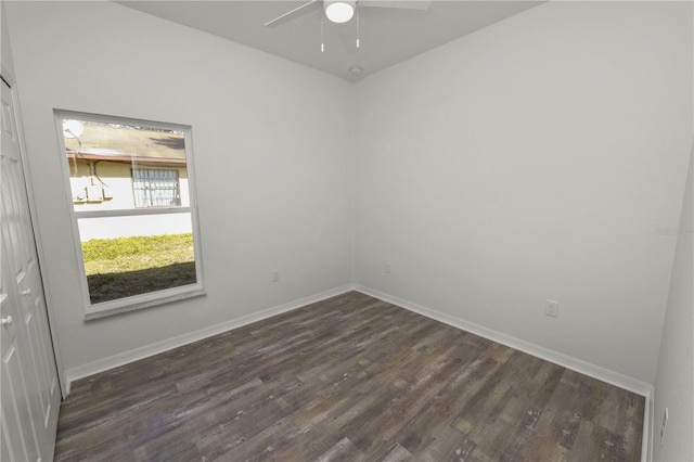 empty room with dark hardwood / wood-style floors and ceiling fan