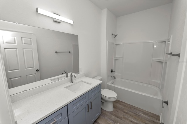 full bathroom with toilet, vanity, bathtub / shower combination, and hardwood / wood-style floors