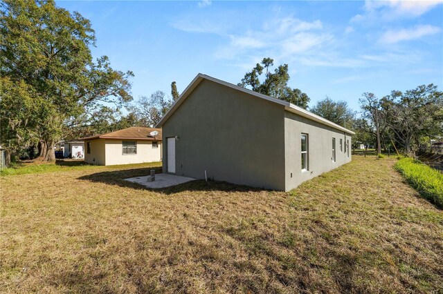 rear view of property with a lawn