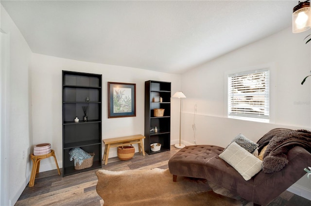 living area with hardwood / wood-style flooring and lofted ceiling