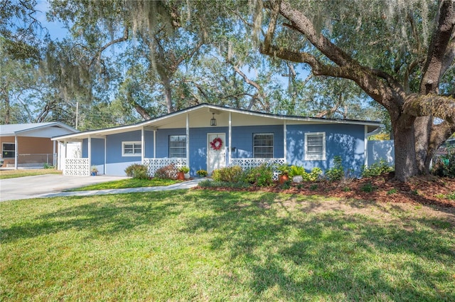 single story home with a carport, a front yard, and covered porch