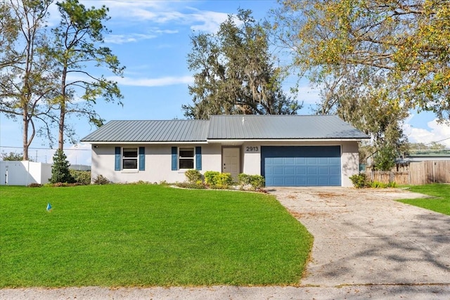 single story home featuring a garage and a front yard