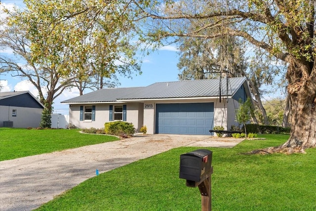 ranch-style home featuring a garage and a front lawn