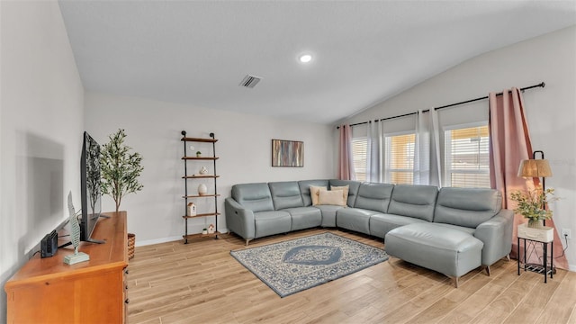 living room featuring vaulted ceiling and light hardwood / wood-style floors