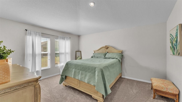 bedroom featuring carpet floors and a textured ceiling