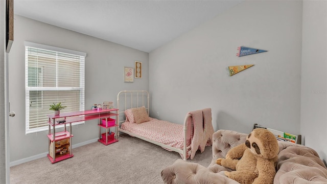 bedroom featuring vaulted ceiling and light colored carpet