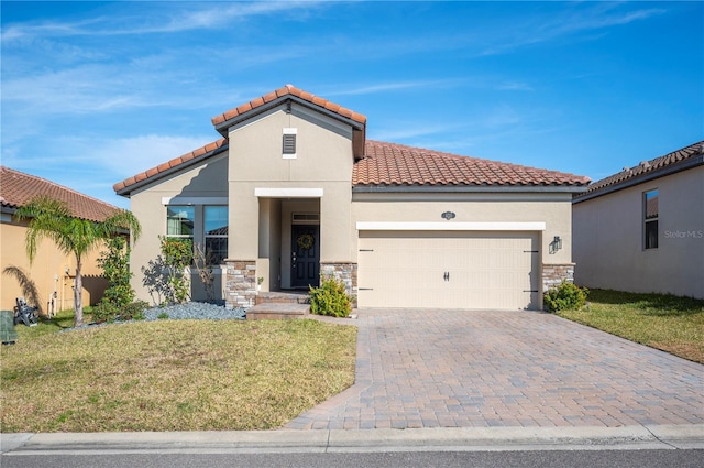 mediterranean / spanish-style house featuring a garage and a front yard