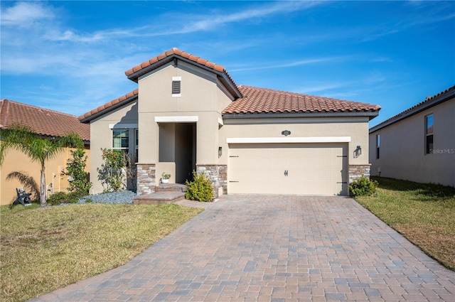 mediterranean / spanish house with a garage and a front lawn