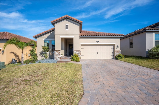 mediterranean / spanish house featuring a garage and a front yard