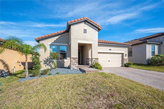 mediterranean / spanish house featuring a garage and a front yard