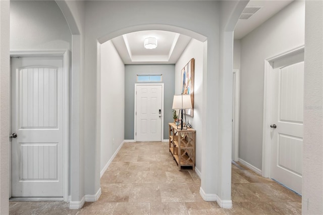 foyer featuring a tray ceiling