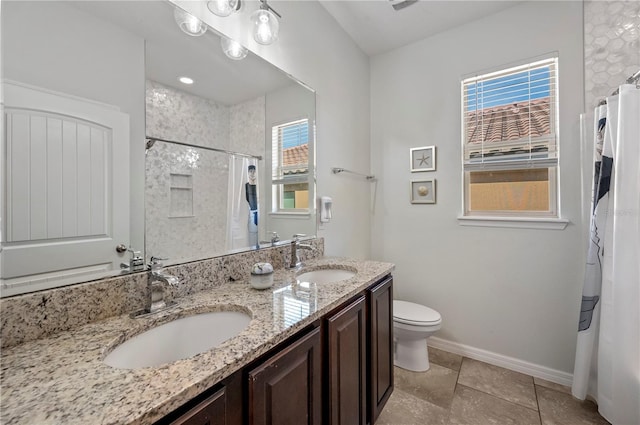 bathroom featuring vanity, curtained shower, and toilet