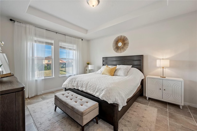 bedroom with a tray ceiling