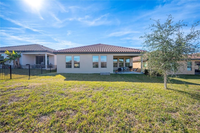 rear view of house featuring a patio and a yard