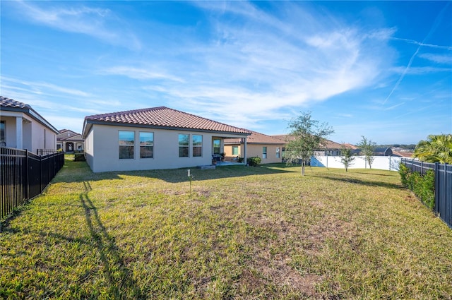 rear view of property featuring a lawn