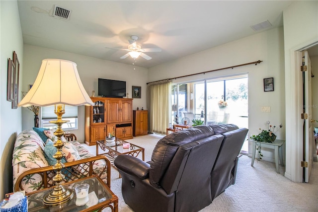 living room with ceiling fan and light colored carpet