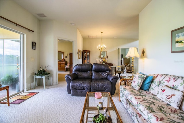 carpeted living room with a chandelier