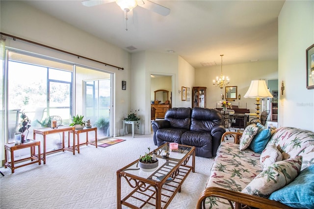 living room with light colored carpet and ceiling fan with notable chandelier