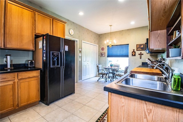 kitchen with sink, black fridge with ice dispenser, decorative light fixtures, and light tile patterned flooring