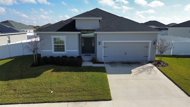 view of front of property with a garage and a front yard