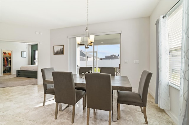 dining room with an inviting chandelier and light tile patterned flooring