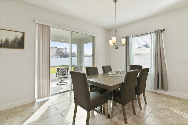 tiled dining room with a water view and a chandelier