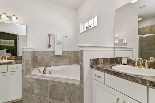 bathroom featuring vanity and separate shower and tub